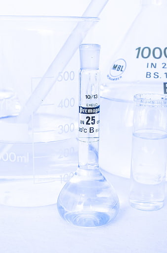 Laboratory glassware with clear liquid and beakers