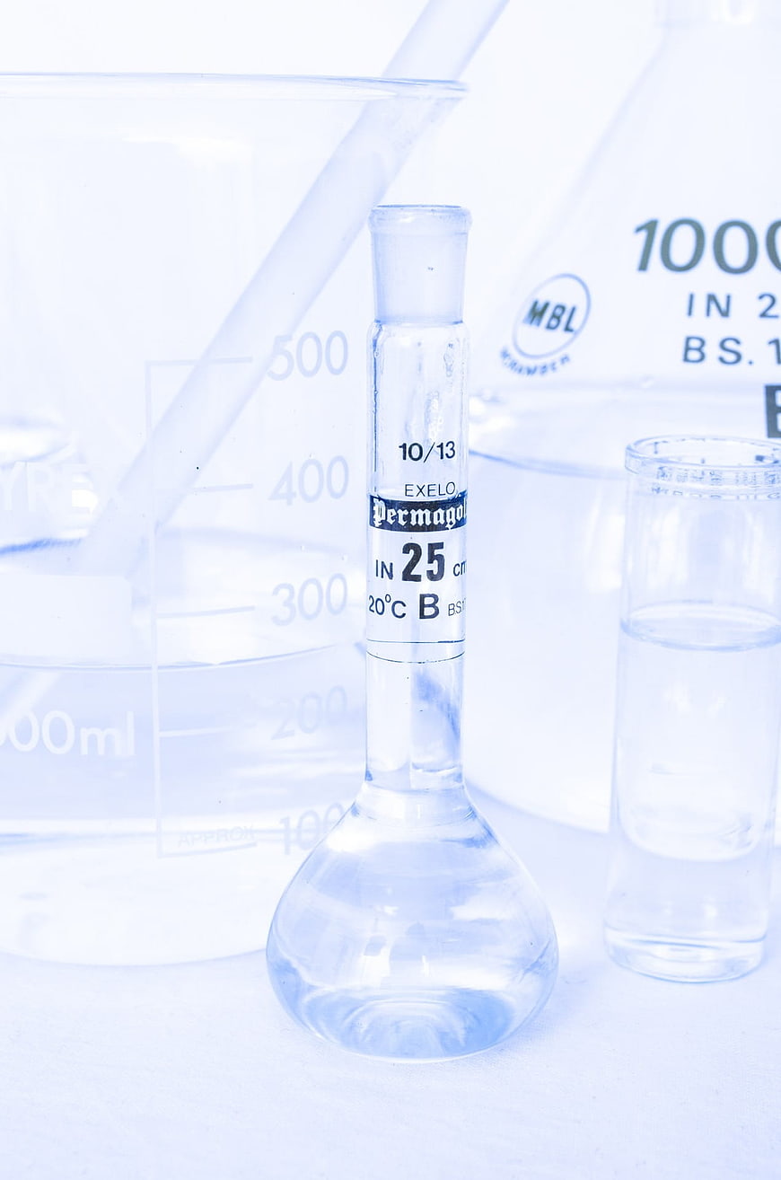Laboratory glassware with clear liquid and beakers