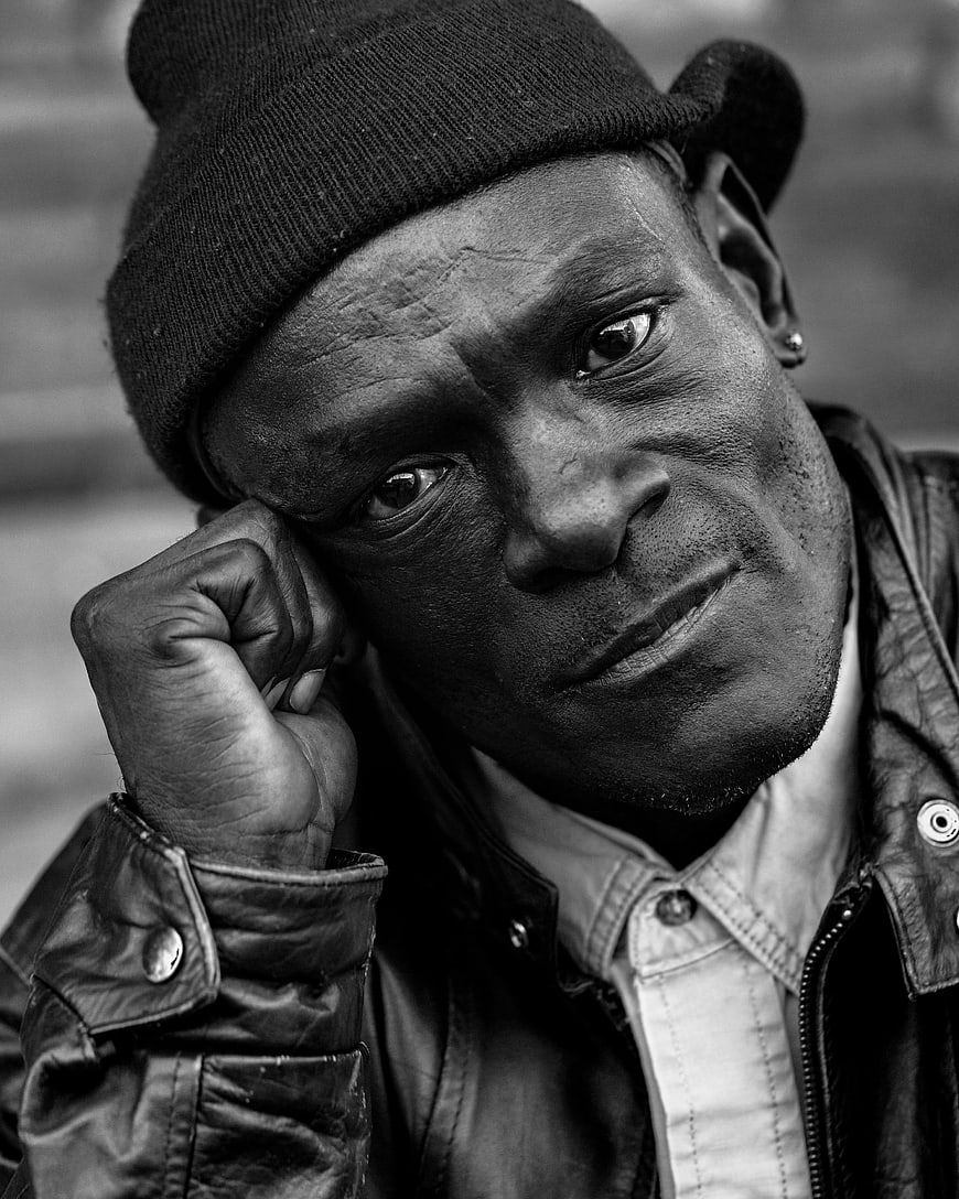 Black and white portrait of a man in a beanie
