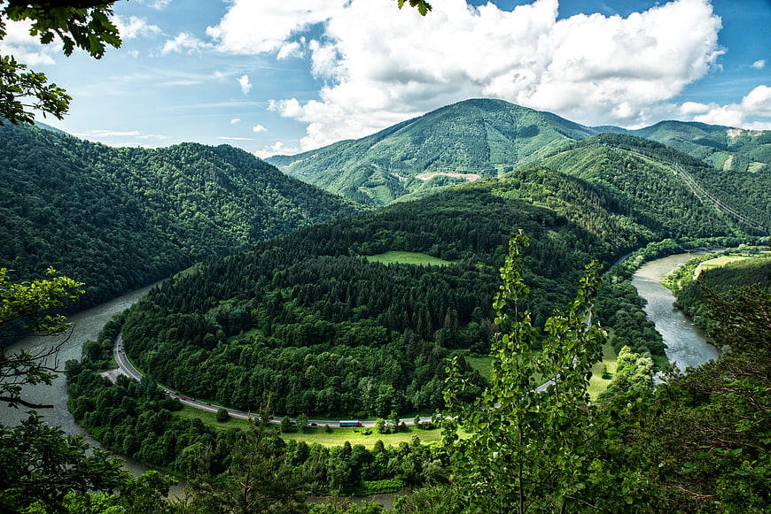 Aerial View of Winding River and Lush Green Mountains