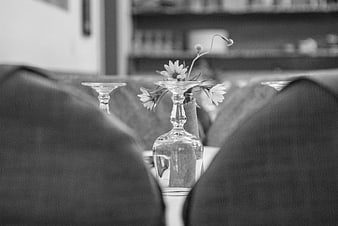 Black and white restaurant table setting with flowers and chairs