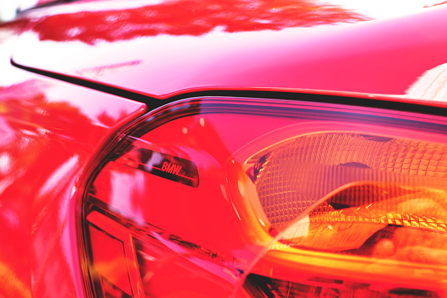 Close-up of Red BMW Headlight Detail