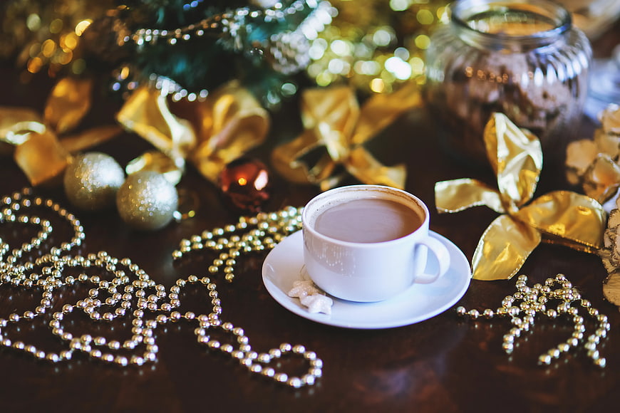 Festive Coffee Cup with Christmas Decorations on Dark Table