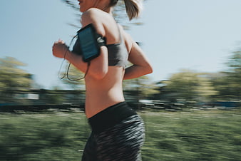 Woman Running Outdoors With Smartphone Armband