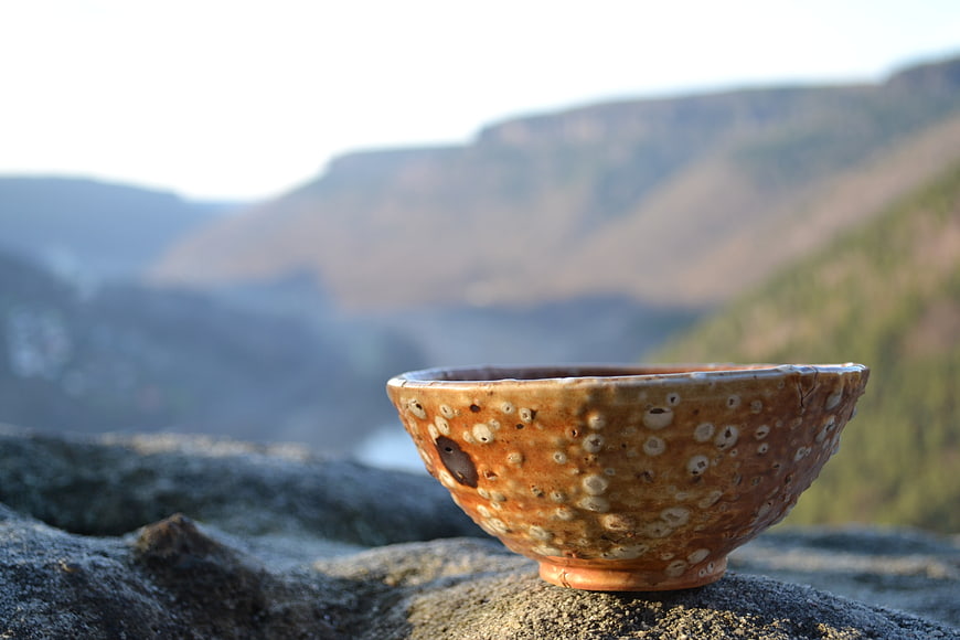 Rustic Handmade Ceramic Bowl on Rocky Mountain Outcrop