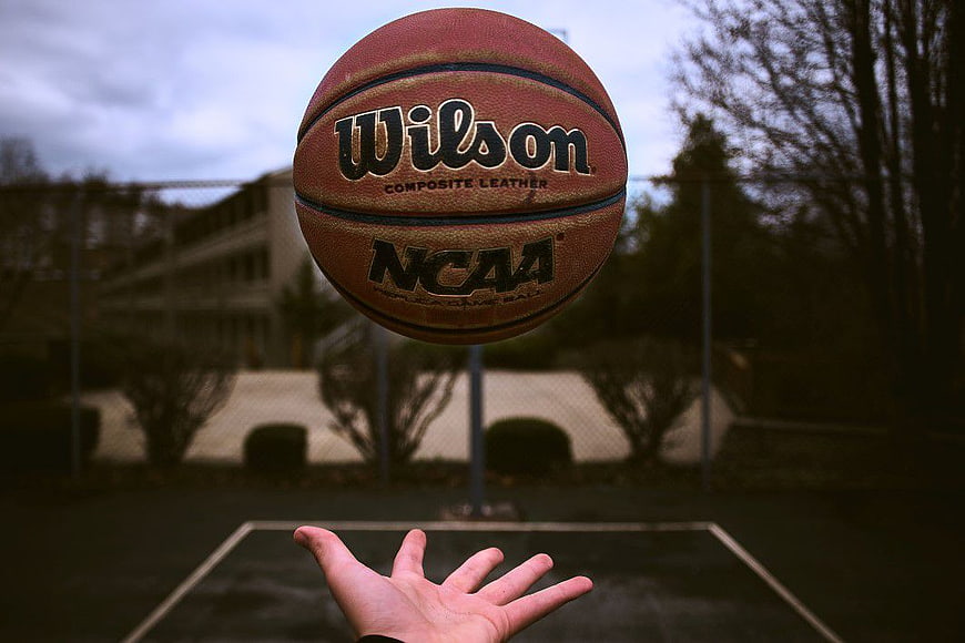 Wilson NCAA Basketball in Mid-Air Above Hand