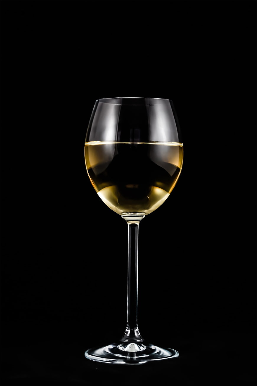 Elegant Glass of White Wine on Black Background