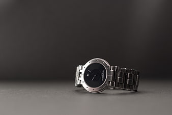 Silver wristwatch on dark gray background