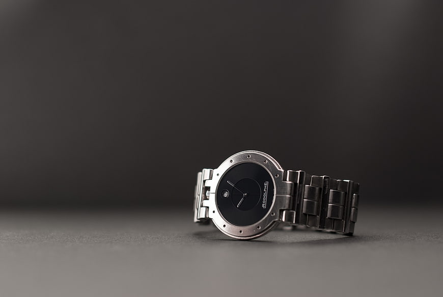 Silver wristwatch on dark gray background