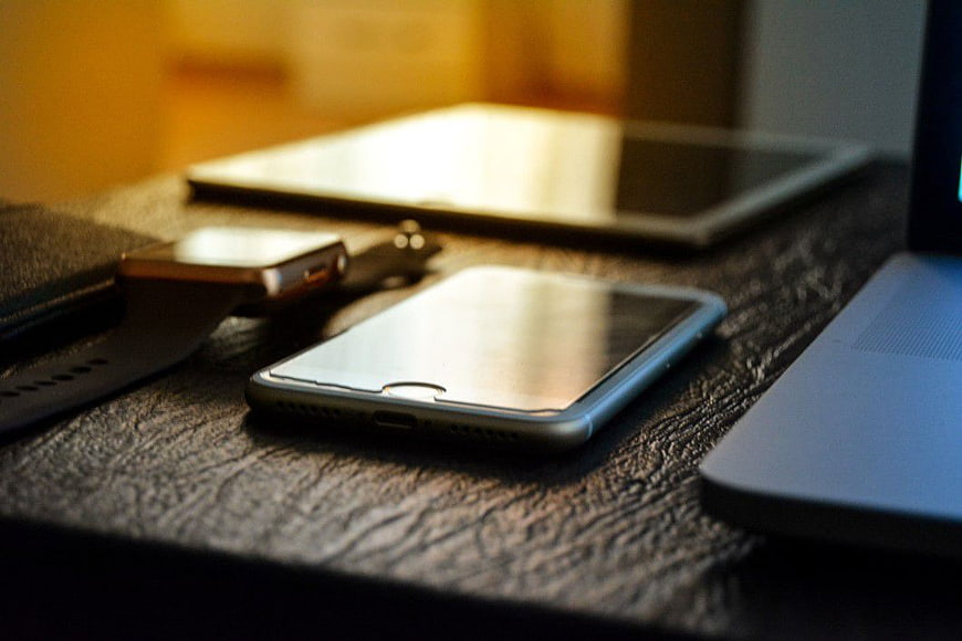 Smartphone, Tablet, and Laptop on Textured Desk Surface