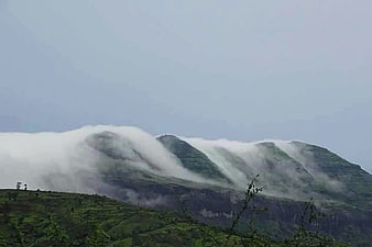 Misty green mountains with rolling clouds in Trimbakeshwar, India