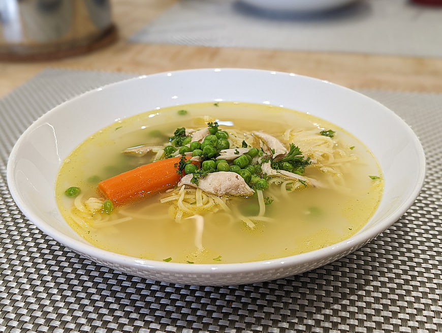 Healthy Chicken Noodle Soup with Vegetables in White Bowl