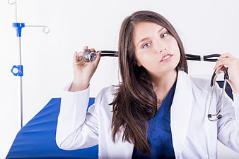Female Doctor Holding Stethoscope in Medical Office