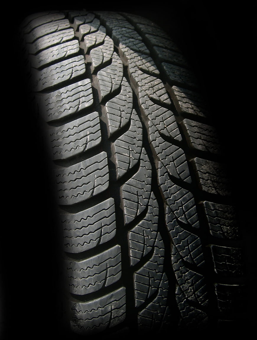 Close-up of winter tire tread pattern on black background