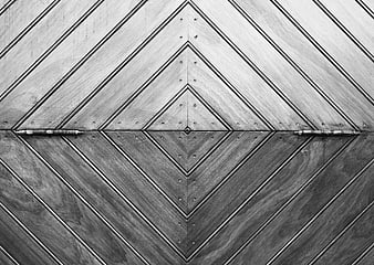 Symmetrical black and white wooden door with geometric pattern