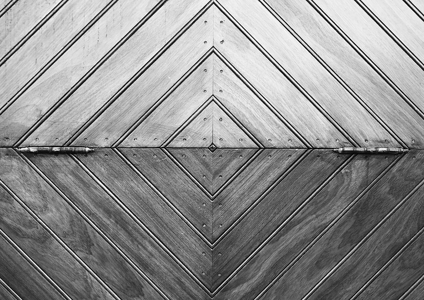 Symmetrical black and white wooden door with geometric pattern