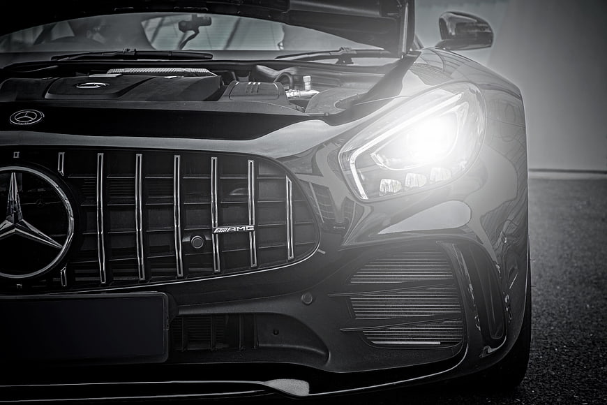 Close-up of Black Mercedes-AMG Front Grille and Headlight