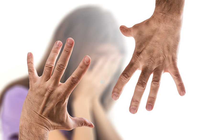 Man's open hand threatening blurred woman in domestic violence concept