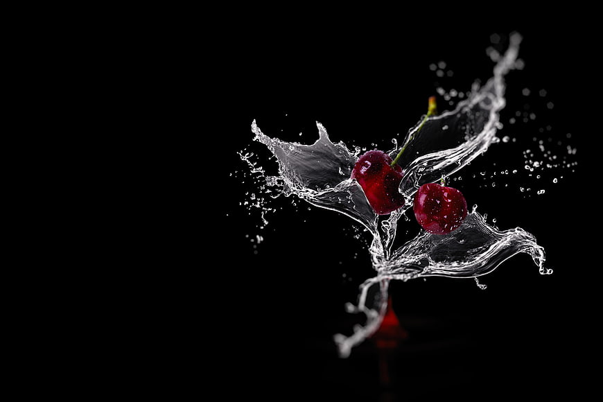 Fresh Red Cherries Splashing in Water on Black Background