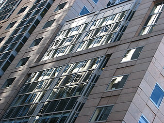 Modern high-rise building facade with glass window reflections