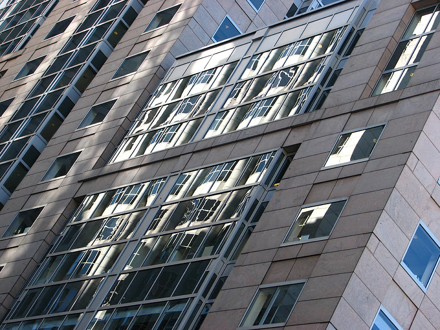 Modern high-rise building facade with glass window reflections