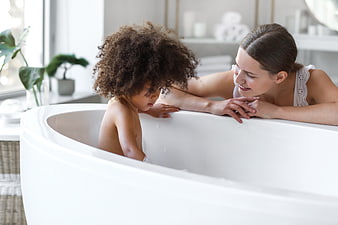 Mother and Child Bonding in Modern White Bathtub