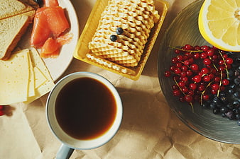 Overhead view of coffee, waffles, cheese, salmon, and berries