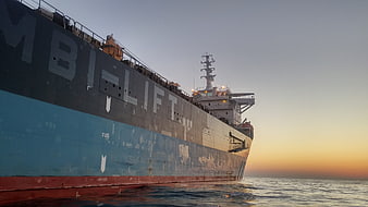 Large cargo ship at sunset on the open sea