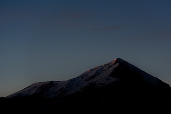 Snowy Mountain Peak at Dusk with Golden Hour Light