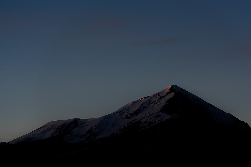 Snowy Mountain Peak at Dusk with Golden Hour Light