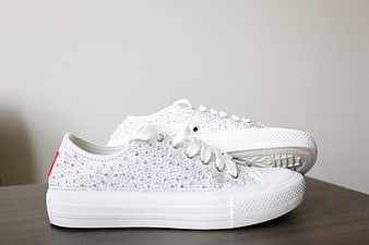White Rhinestone Sneakers on Wooden Surface