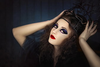 Gothic woman with dramatic purple eye makeup and red lips