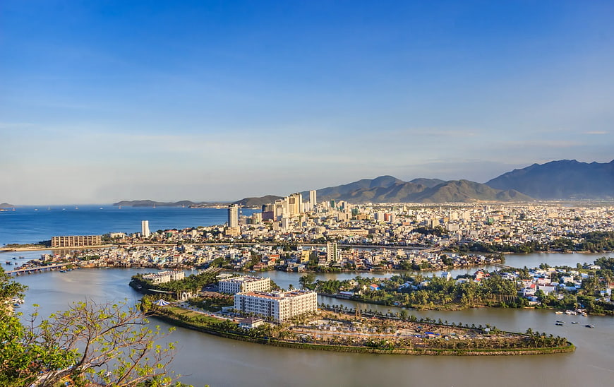 Aerial View of Coastal City with River and Mountains