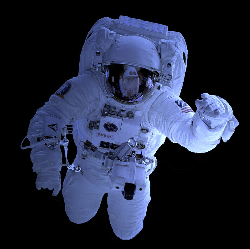 Astronaut in NASA spacesuit floating in space