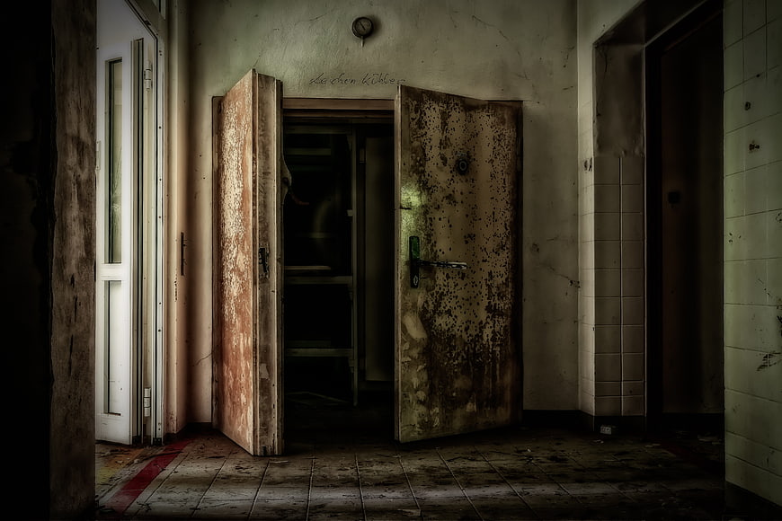 Abandoned Dilapidated Building Interior with Rusty Double Doors