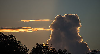 Dramatic sunset cloud formation over silhouetted trees
