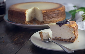 Creamy Cheesecake Slice with Berry Topping on Wooden Table