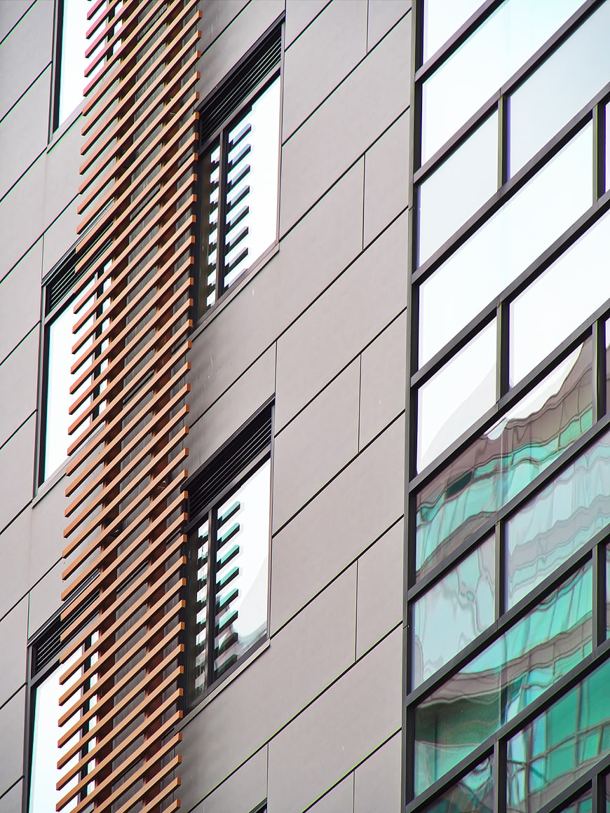Modern Building Facade with Wooden Slats and Glass Windows
