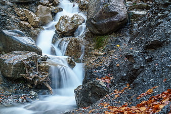 Long Exposure Mountain Stream Flowing Over Rocks in Autumn