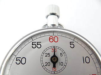Close-up of a silver stopwatch dial with red and black numbers on a white background