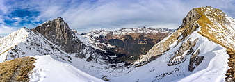 Panoramic View of Snow-Covered Mountain Peaks and Valley