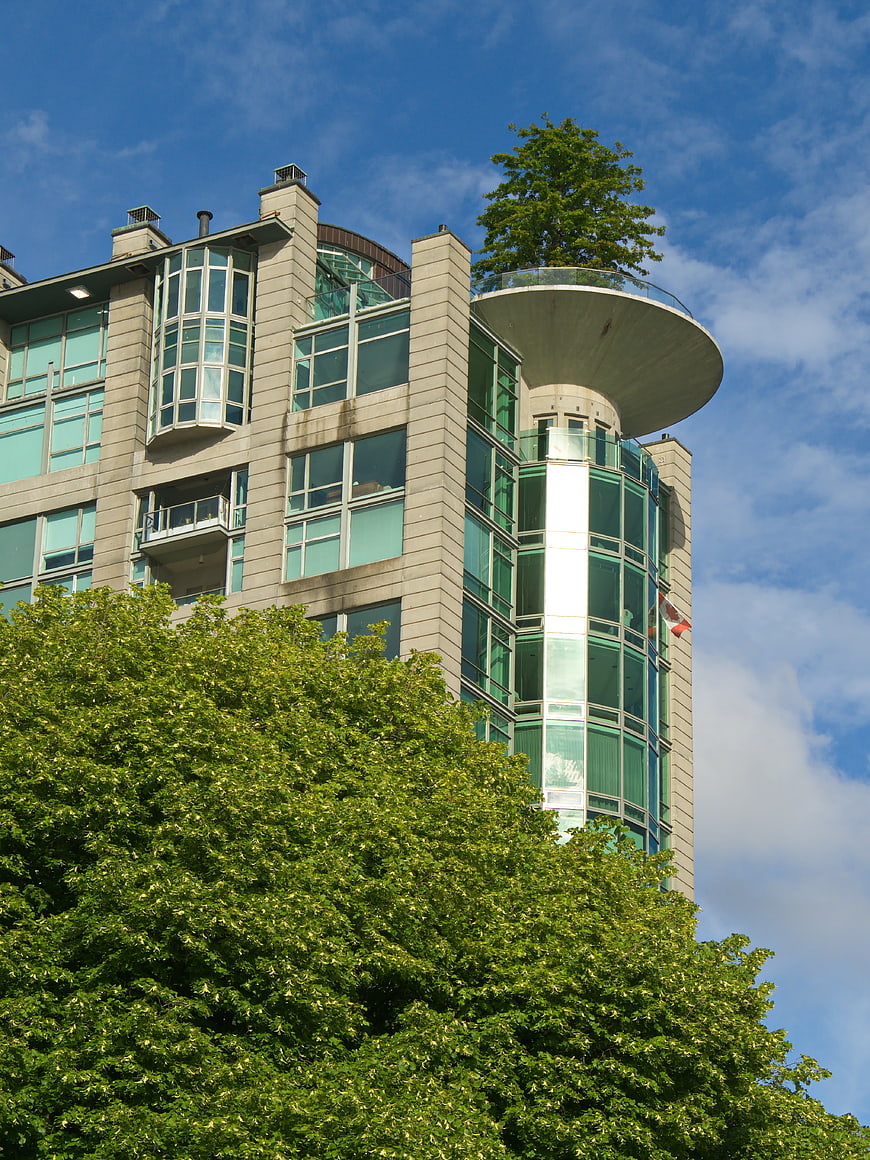 Modern Apartment Building with Rooftop Tree and Glass Facade