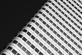 Black and white modern skyscraper facade with grid pattern