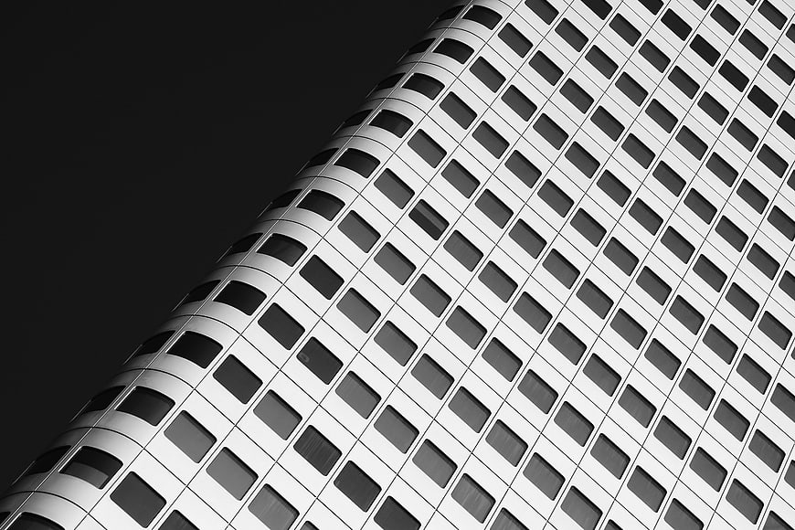 Black and white modern skyscraper facade with grid pattern