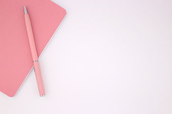 Minimalist pink notebook and pen on white background
