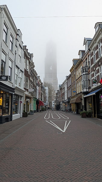 Foggy Dutch Street with Church Tower in the Distance