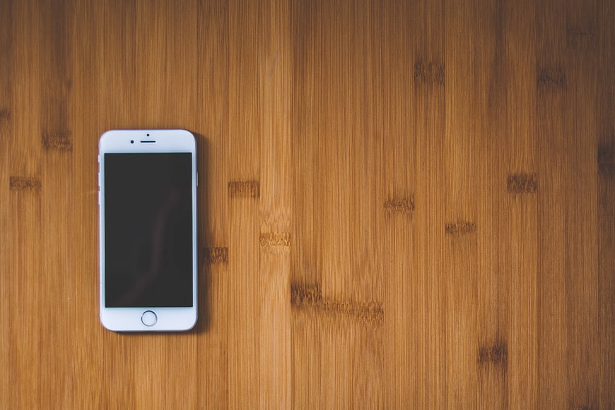White Smartphone on Wooden Surface with Copyspace