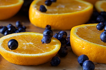 Fresh Sliced Oranges and Blueberries on Wooden Surface