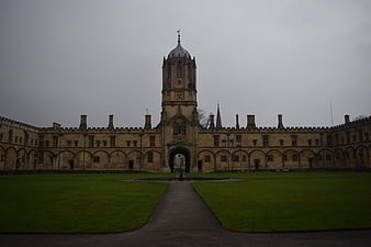 Symmetrical historic university courtyard with central clock tower