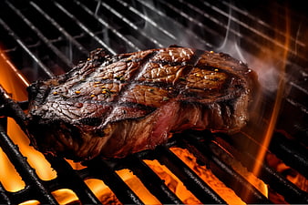 Juicy Grilled Steak Sizzling on Barbecue Grill with Flames